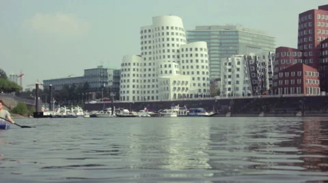 Kayaking in front of modern buildings Stock Footage 41595151