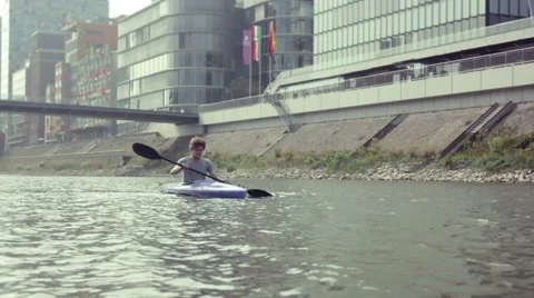 Kayaking in front of office buildings Stock Footage 41595419