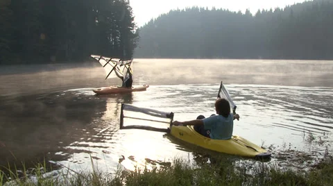 Kayaking in the lake during sunrise time Stockbeeldmateriaal 31145872