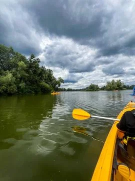 Kayaking on the lake under dramatic cloudy sky Stock Photos