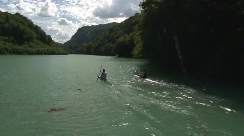 Kayaking at mountain river, two kayakers passing by the frame. Video stock 61342820