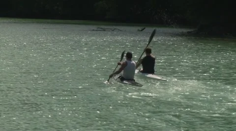 Kayaking at mountain river, two kayakers passing by the frame. Video stock 61343782