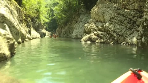 Kayaking on a narrow mountain river, floating camera Video stock 256676069