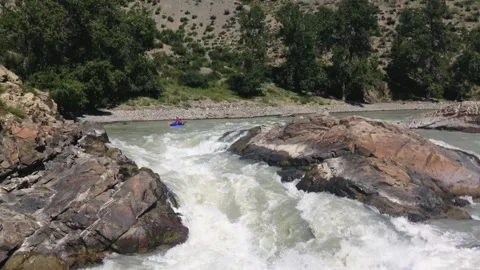 Kayaking on the rapids of a mountain river with paddles. Extreme sport. Stock Footage 237691353