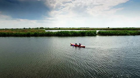 Kayaking on the river between the reeds Stock Footage 64345841