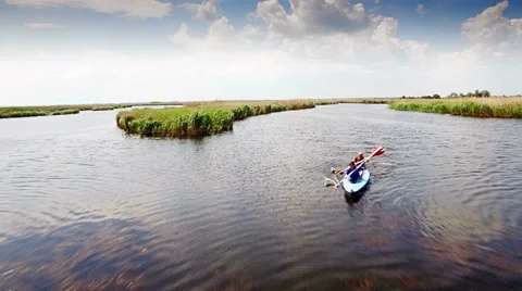 Kayaking on the river between the reeds Stock Footage 64346169