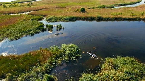 Kayaking on the river between the reeds Stock Footage 64353661