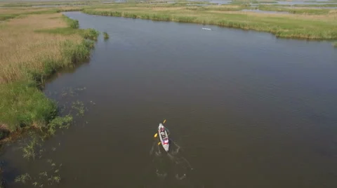 Kayaking on the river between the reeds Stock Footage 64513296