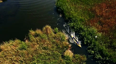 Kayaking on the river between the reeds Stock Footage 64515572