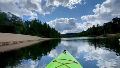 Kayaking on the river Gauja, exploring beaches, green kayak boat, sky Stock Footage 248716513