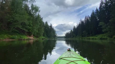 Kayaking on the river Gauja, exploring nature, green kayak boat around the Stock Footage 248716489