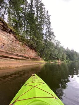 Kayaking on the river Gauja, exploring rocks, green kayak boat Stock Photos