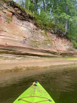 Kayaking on the river Gauja, exploring rocks, green kayak boat Stock Photos