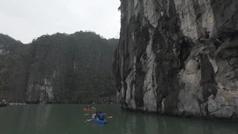 Kayaking slowly at halong bay on a cloud day Stock Footage 288568203