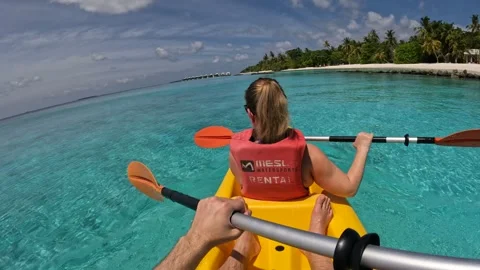 Kayaking through crystal clear waters in the Maldives on a sunny afternoon Video stock 286105189