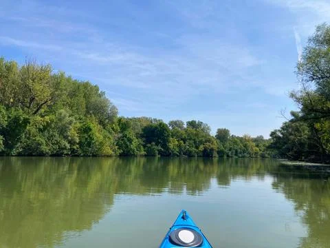 Kayaking Through a Serene Forest-Lined River Stock Photos