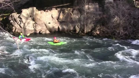 Kayaks 2 past quick L to R with rock cliff other side  clip41 Stock Footage 265499416