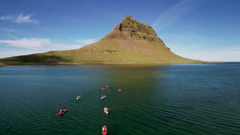Kayaks of different colors float on the water in the ocean Stock Footage 252838909
