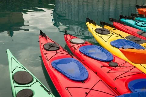 Kayaks in Multiple Color Float Marine Harbor Red Teal Yellow and Orange Ka... 写真素材