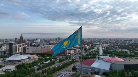 Kazakhstan flag waving in the wind overlooking the city of astana Stock Footage 321897274
