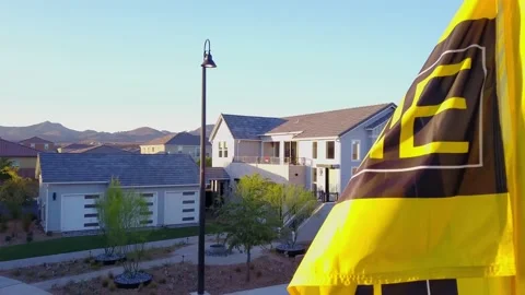 KB homes flag waving in front of new home Stock Footage 154332807