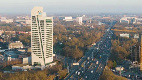 Kbc tower sharp architectural lines dominate busy highway wooded areas scattered Vídeos de archivo 329086366