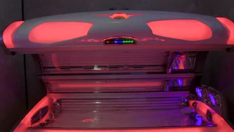A KBL Tanning Bed With Ultraviolet Lamps In A Tanning Salon - tilt down Stock Footage