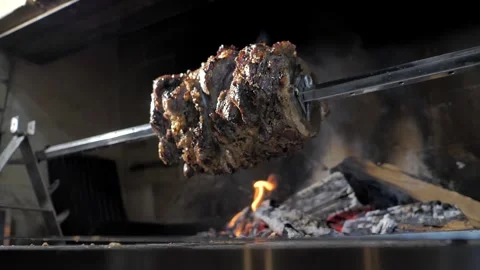 Kebab. Doner. Chef in black gloves rotates a spit of meat on coals Stock Footage 201819607
