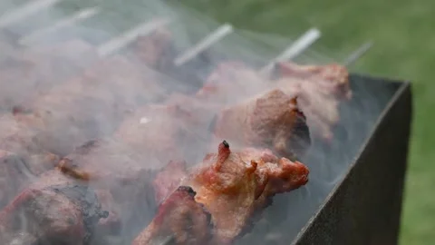 Kebab is fried on the grill. The meat is fried over charcoal in smoke. Stock Footage 133760605