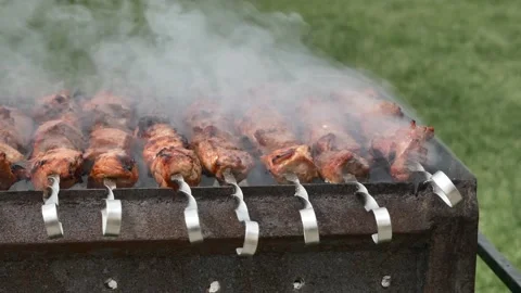 Kebab is fried on the grill. The meat is fried over charcoal in smoke 01 Stock Footage 133760640