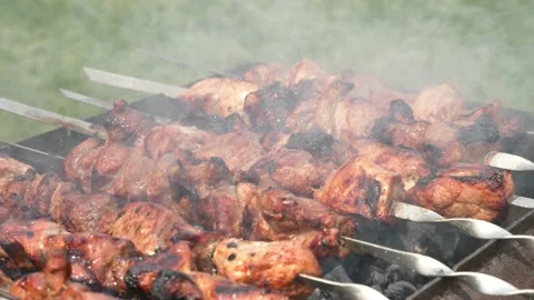 Kebab is fried on the grill. The meat is fried over charcoal in smoke. Stock Footage 133760650