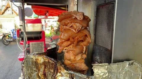 Kebab (kabob) raw chicken rotating beside electric kebab heater, Thailand Stock Footage 232094493