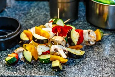Kebab of vegetables and cucumbers on a wooden skewer. Stock Photos