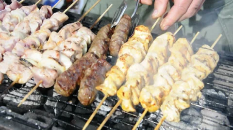 Kebabs being turned on a grill Stock Footage 32931723