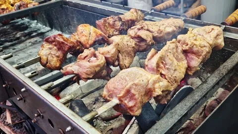 Kebabs on skewers, automatic grill close-up. Food Video stock 259627294