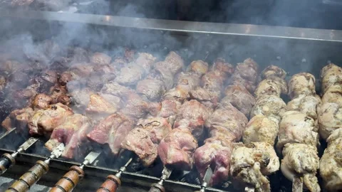 Kebabs on skewers, automatic grill close-up. Food court at the fair, outdoor Stock Footage 304702754