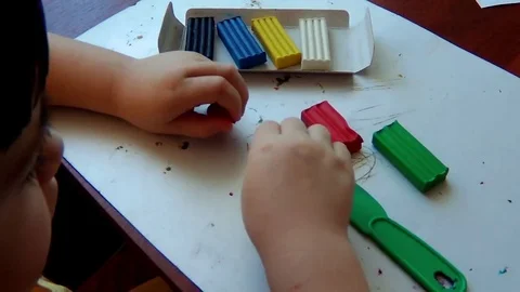A keen child with colored plasticine Stock Footage 74389977