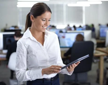 Keep abreast of online developments. A gorgeous young business woman using her Foto stock