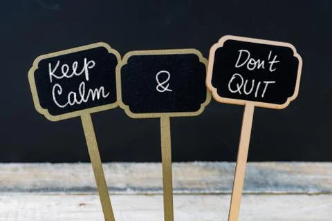 Keep Calm and Do Not Quit message written with chalk on mini blackboard label Stock Photos