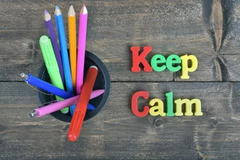 Keep calm on wooden table Photos
