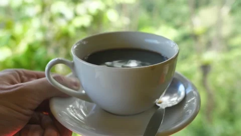 Keep a cup of coffee on a saucer. The coffee will allow you to enjoy its real Stock Footage 197286062