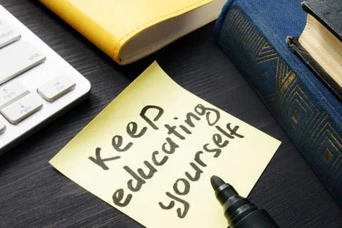 Keep educating yourself. Book and keyboard. Lifelong learning. Stock Photos