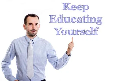 Keep Educating Yourself (KEY) - Young businessman with small beard pointing.. Stock Photos