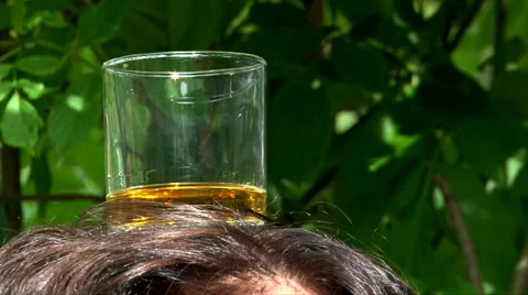 Keep Glass Of Whiskey On Head, Close Up Shot Video stock 62945752