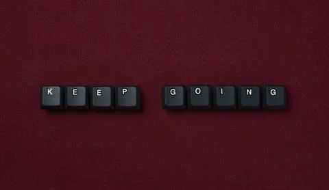 Keep Going Motivation Concept With Keyboard Keys On Red Background Stock Photos