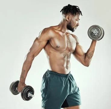 Keep going until youve reached all your goals. a muscular young man lifting Stock Photos