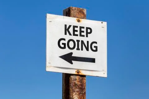Keep going word and arrow signpost Stock Photos