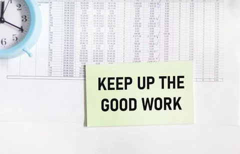 Keep Up The Good Work text message written on a notebook with financial docum Stock Photos