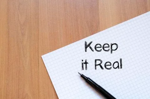 Keep it real write on notebook Stock Photos