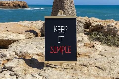Keep it simple symbol. Concept word Keep it simple on beautiful black chalk.. Stock Photos